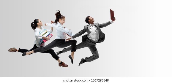 Happy office workers jumping and dancing in casual clothes or suit with folders on white. Ballet dancers. Business, start-up, working open-space, motion and action concept. Creative collage. Copyspace - Powered by Shutterstock
