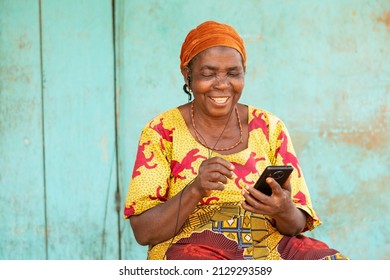 Happy Old African Woman Using Her Phone, Listening To Music