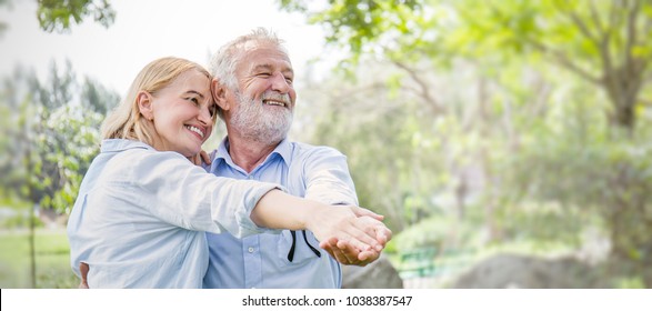 Happy Old Caucasian Couple Smiling Dancing In A Park On Sunny Day, Hoot Senior Couple Relax In Park Spring Summer Time. Healthcare Lifestyle Retirement Married Grandparents Wellbeing Panoramic Banner