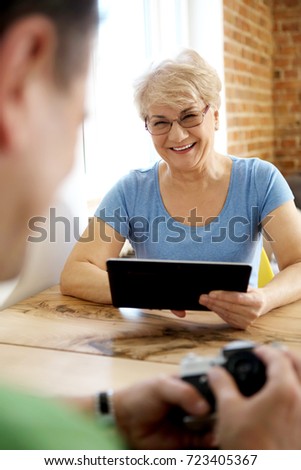 Happy old couple with camera.