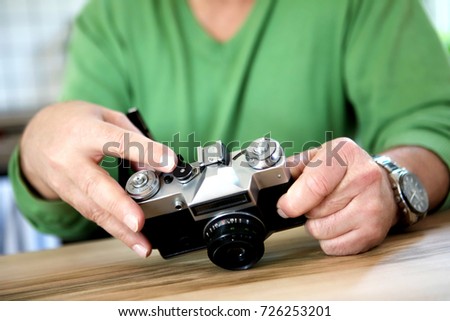 Happy old couple with camera.