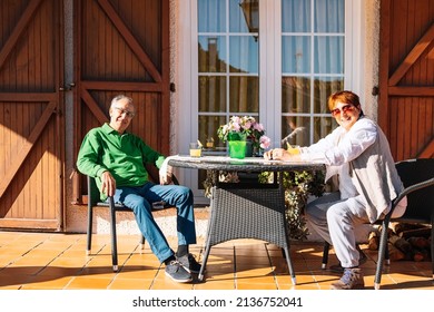 happy old couple enjoying the spring, relaxing on the porch of their home - Powered by Shutterstock