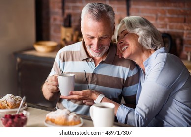 Happy old couple having coffee together - Powered by Shutterstock