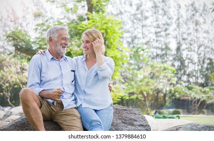 Happy Old Elderly Caucasian Couple Smiling In Park On Sunny Day, Hoot Senior Couple Relax In Spring Summer Time. Healthcare Lifestyle Elderly Retirement Love Couple Together Valentines Day Concept 