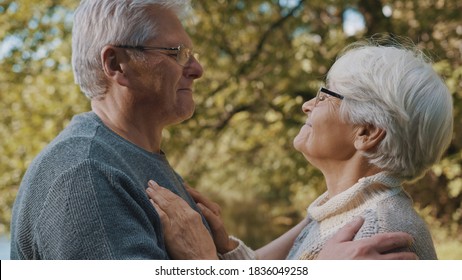 Happy Old Enjoying Day In Park. Senior Man Flirting With Elderly Woman. Dance In Autumn Day. High Quality Photo