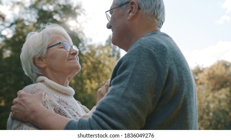 Happy Old Enjoying Day In Park. Senior Man Flirting With Elderly Woman. Dance In Autumn Day. High Quality Photo