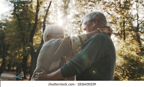 Happy Old Enjoying Day In Park. Senior Man Flirting With Elderly Woman. Dance In Autumn Day. High Quality Photo