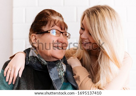 Similar – Woman taking selfie with older mother in wheelchair