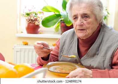 Happy Old Gray-haired Woman Eating Soup