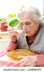 Happy Old Gray-haired Woman Eating Soup