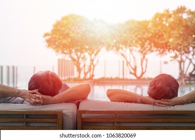 Happy Old Husband And Wife In Hospice Residence. Relax Easy Senior Retire Woman And Man Couple Lifestyle Sitting At Swimming Pool In Nursing Home Society. People And Business Concept.