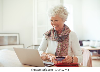 Happy Old Lady Doing Some Shopping Online Using Her Laptop