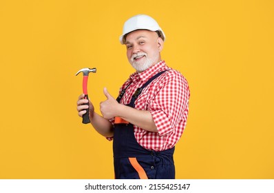 happy old man carpenter in helmet on yellow background. thumb up - Powered by Shutterstock