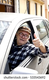 Happy Old Man Driving A Car