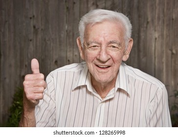 Happy old man giving thumbs up