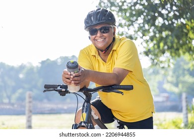 Happy Old Man Leaning On Bicycle Handlebar