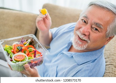 Happy Old Man Positive, Mature Man With Pumpkin And Healthy Food, Portrait Asian Senior Man Eating A Salad In House, Old Elderly Male Health Care Eat Vegetables And Useful Foods.