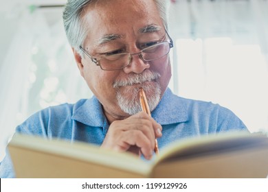 Happy Old Man Positive, Portrait Asian Senior Man Reading Book Or Writing Notebook, Old Elderly Male Health Care And Retirement Concept.