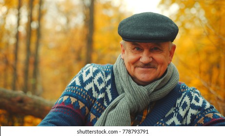 Happy Old Man Is Smiling In The Autumn Park