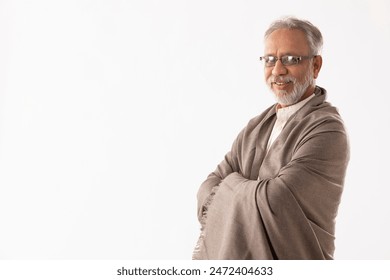 A HAPPY OLD MAN STANDING AND SMILING AT CAMERA