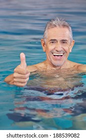 Happy Old Man In Swimming Pool Holding His Thumbs Up