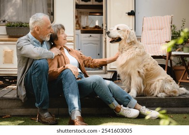 Happy old senior caucasian couple spouses traveling with their dog golden retriever labrador in camper van. Holidays with pets. Active wild life - Powered by Shutterstock