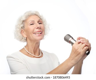 Happy Old Woman Holding A Microphone And Singing Isolated