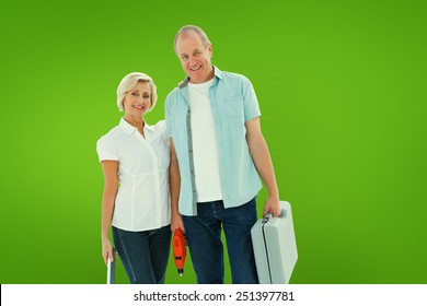 Happy Older Couple Holding Diy Tools Against Green Vignette