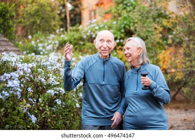 Happy Older Couple In Matching Outfits Talking About Something Outside