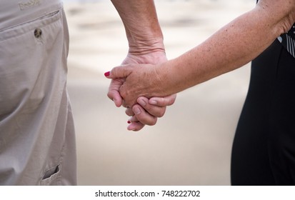 Happy Older Couple On The Beach