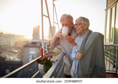 Happy older couple spending morning together on the balcony - Powered by Shutterstock