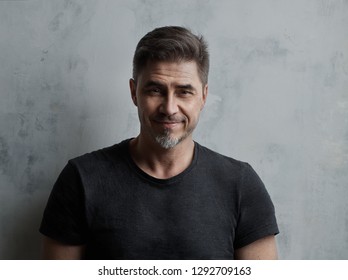 Happy Older Man In Casual Tshirt Smiling Isolated On White Background.