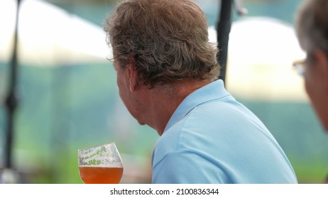 Happy Older Man Drinking Beer With Friends