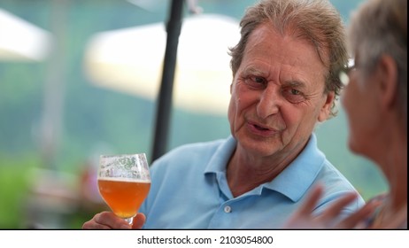 Happy Older Man Drinking Beer With Friends