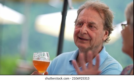 Happy Older Man Drinking Beer With Friends