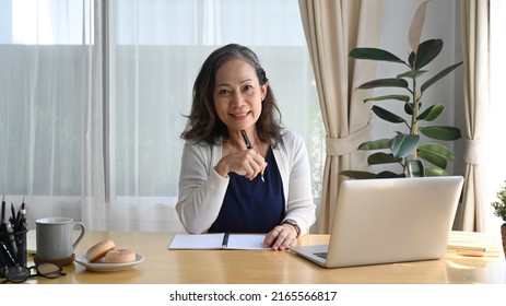 Happy Older Mature Woman, Checking Email, News Online, Watching Webinar Or Working On Computer Laptop At Home