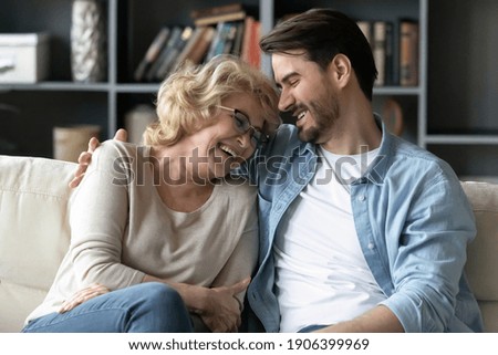 Similar – Image, Stock Photo Mother and son having fun while studying documents on yellow file
