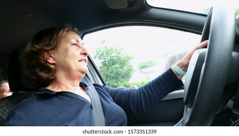 
Happy Older Woman Driving Holding Steering Wheel