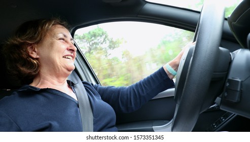 
Happy Older Woman Driving Holding Steering Wheel