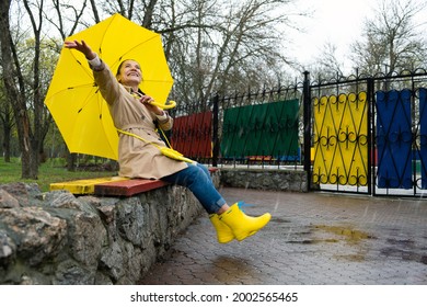 Happy Older Women Having Fun Outdoor. Senior Cheerful Mature Elderly Retired Woman With Yellow Umbrella Enjoying Life At Rainy Day In Park. Enjoying Life, Positive Emotions, Happy Retirement