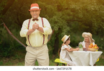 Happy Oldman In Red Hat Shows Thumb Up Sign In Summer Garden. Eld Concept.