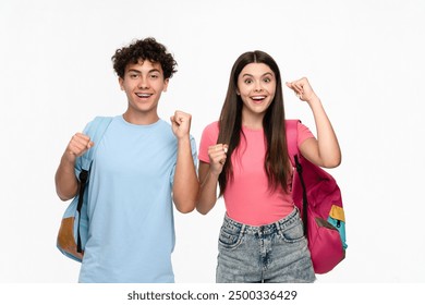 Happy overenjoyed winners high school pupils students teenagers classmates boy girl in casual with rucksacks celebrating having success great news winning gesture isolated on white background. - Powered by Shutterstock