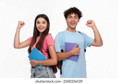 Happy overenjoyed winners high school pupils students teenagers classmates boy girl in casual with bag holding copybooks celebrating having success winning gesture isolated on white background. - Powered by Shutterstock