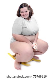 Happy overweight woman riding on a little hobby horse. Conceptual image. Funny leisure metaphor.