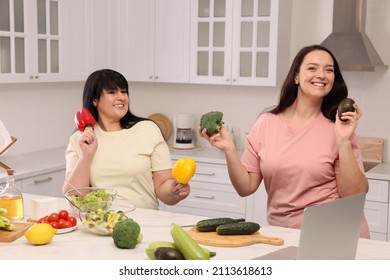 Happy Overweight Women Having Fun While Cooking Together In Kitchen