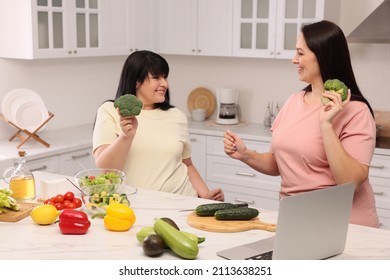 Happy Overweight Women Having Fun While Cooking Together In Kitchen