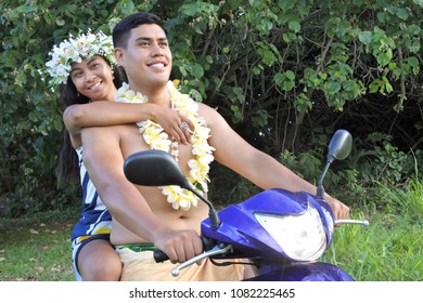 Happy Pacific Islander  Honeymoon Couple Riding Motor Scooter Along Country Road In Rarotonga, Cook Islands. Real People Copy Space