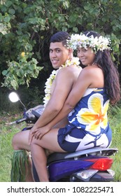 Happy Pacific Islander  Honeymoon Couple Riding Motor Scooter Along Country Road In Rarotonga, Cook Islands. Real People Copy Space