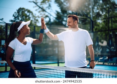 Happy paddle tennis players congratulating each other on well played match. Copy space.  - Powered by Shutterstock