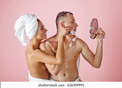 Happy Pair Of Male And Female Embracing. Bathroom Routine For Happy Young Couple. Man Gritting Teeth Shaving With Razor Burn. Family Concept. Wellness. Bath. Love Concept. Fashion. Love Story. Secret